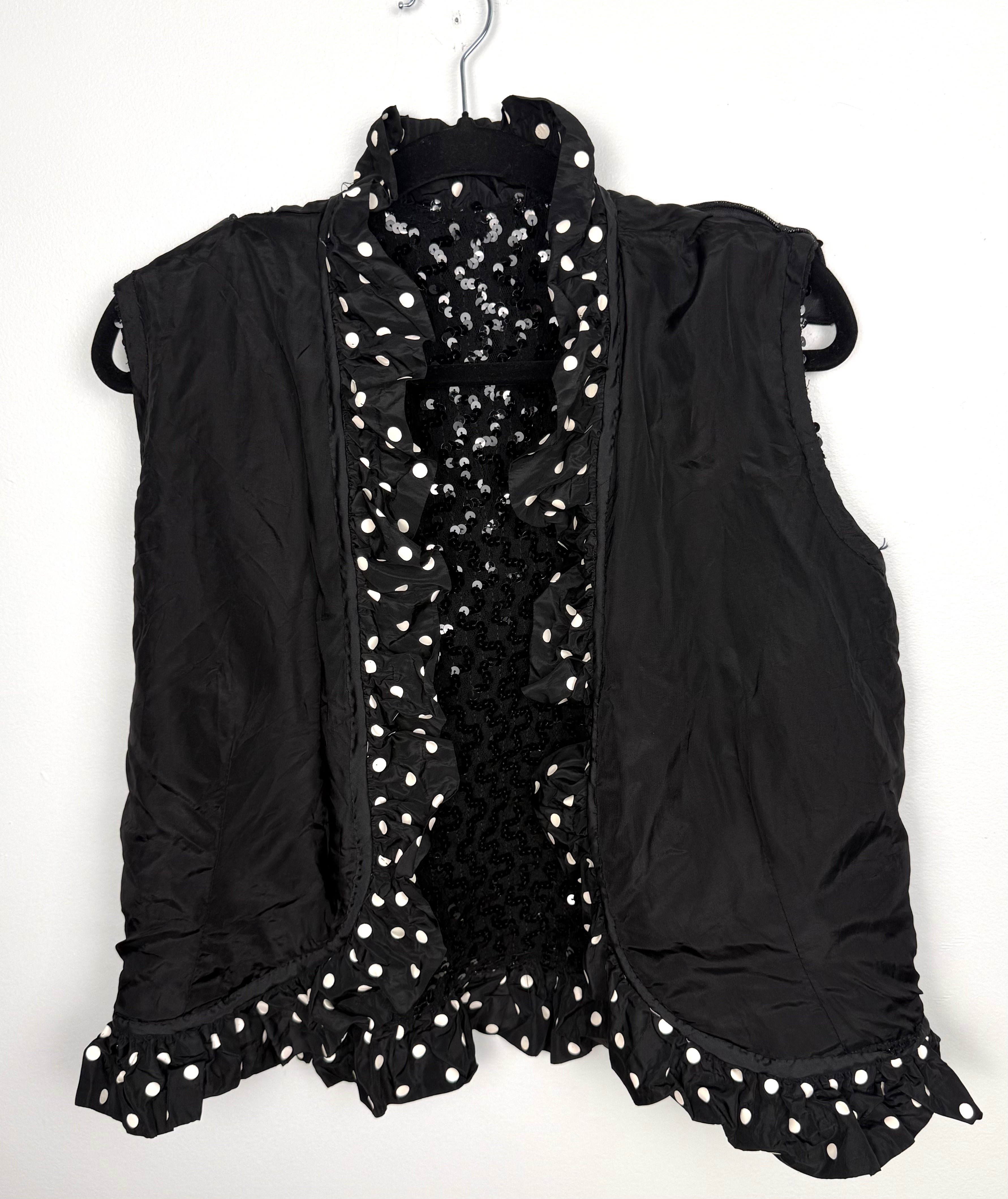 Interior lining and ruffle trim detail black vest