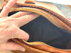 Interior of vintage leather handbag showing clean lining and zip closure