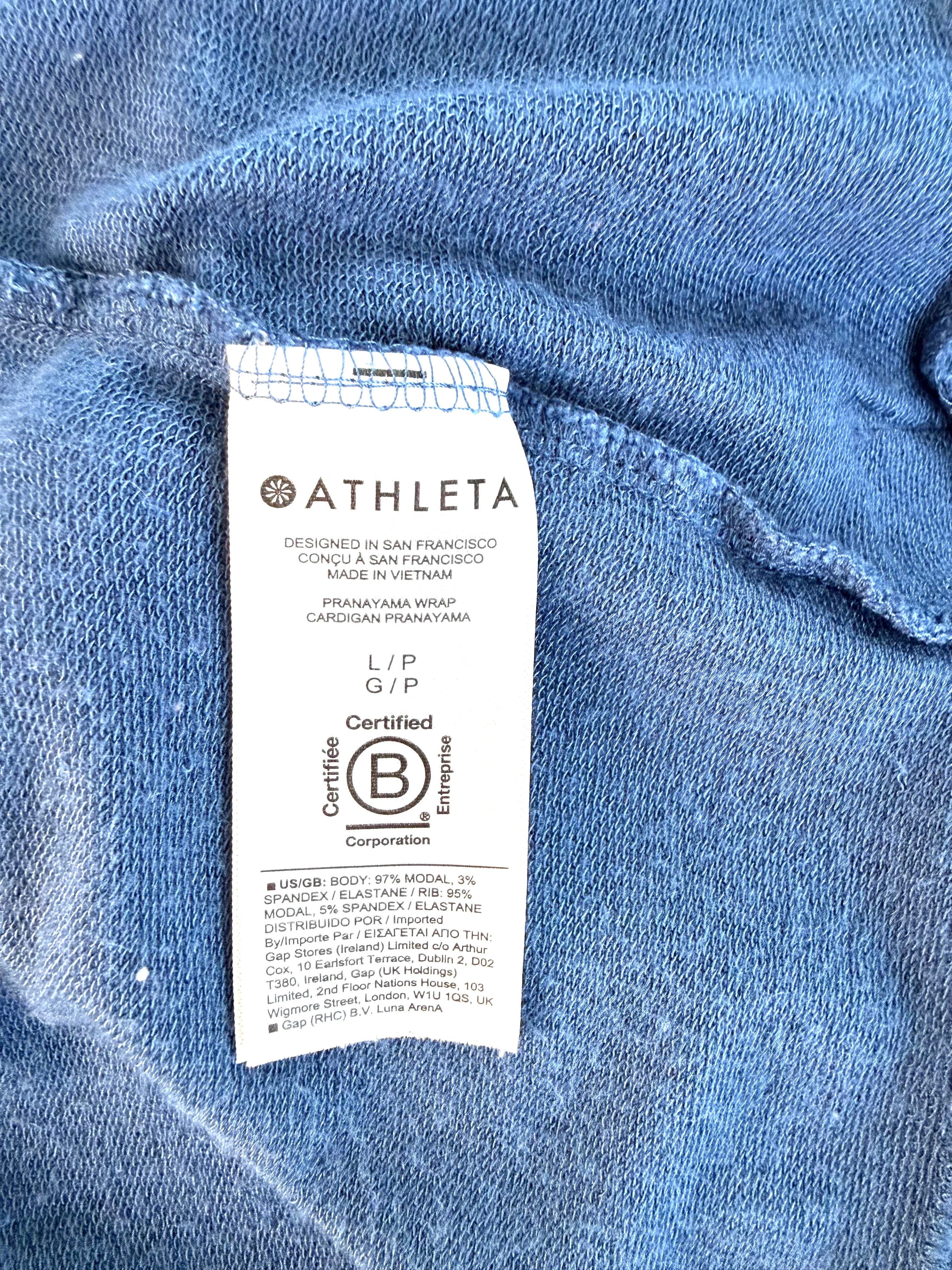 Interior tag showing Pranayama Wrap cardigan style name and modal spandex fabric blend.