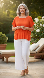 Juanita Banana artisan-made Mexican 100% cotton burnt orange batwing peplum top size M — Blue Sparrow pre-loved women's fashion on woman with white wide leg pants