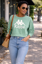 Kappa Cropped Sweatshirt in mint green at Blue Sparrow Shop on a woman in the street 