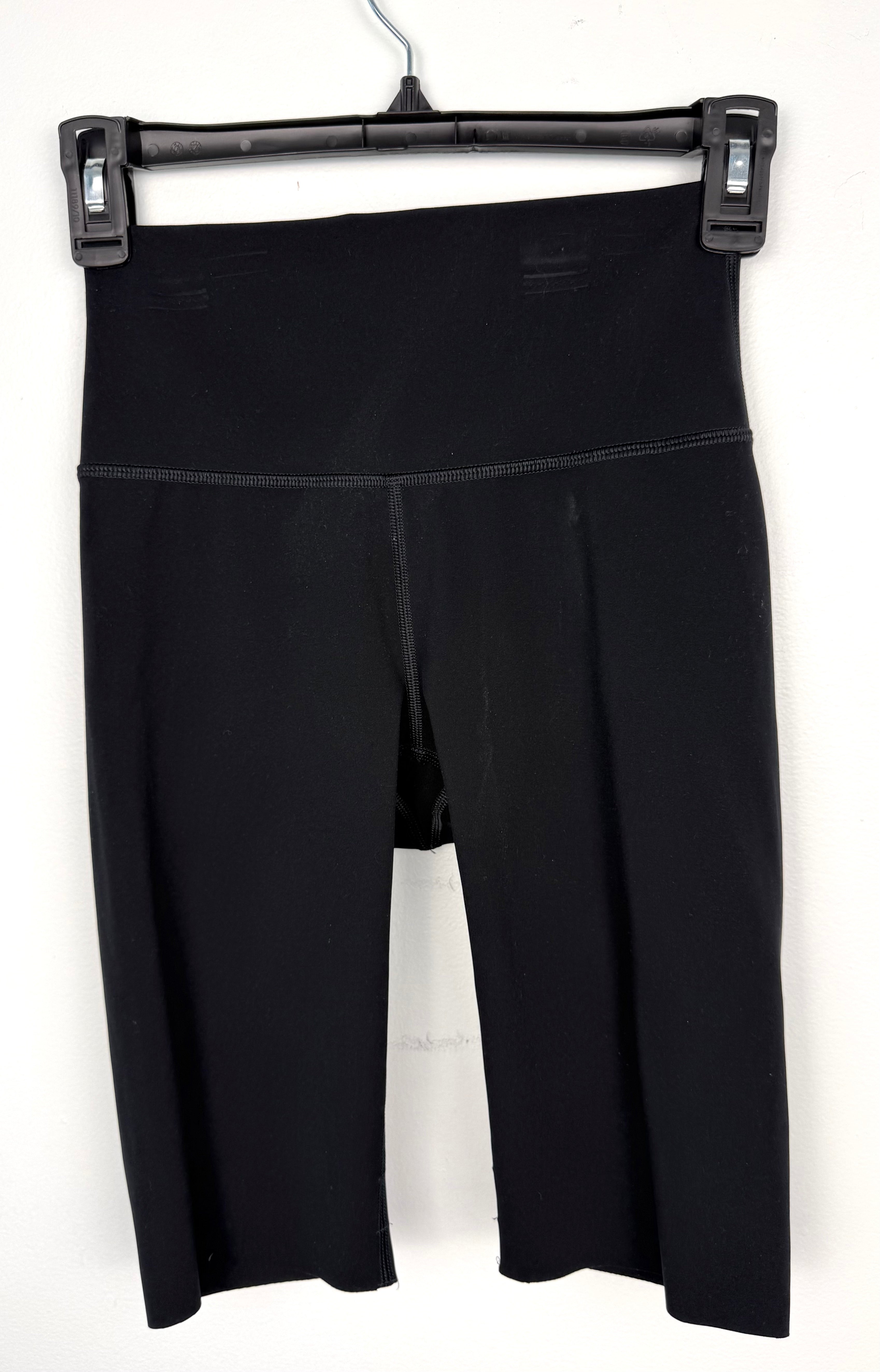 Kit and Ace black high-waist biker shorts on hanger 