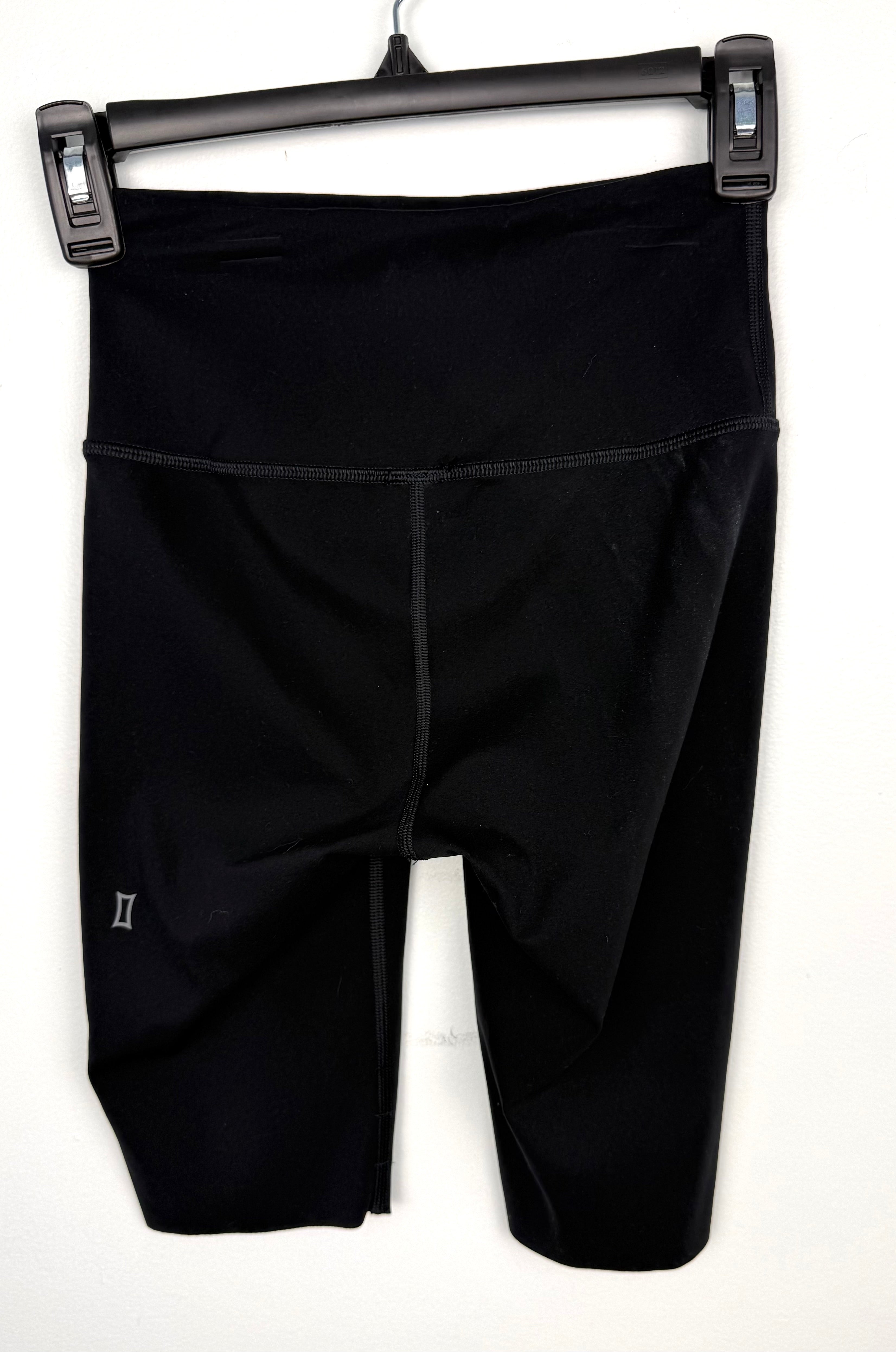 back of Kit and Ace black high-waist biker shorts showing logo