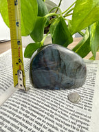 Labradorite with measuring tape showing it to be about 3 inches high 