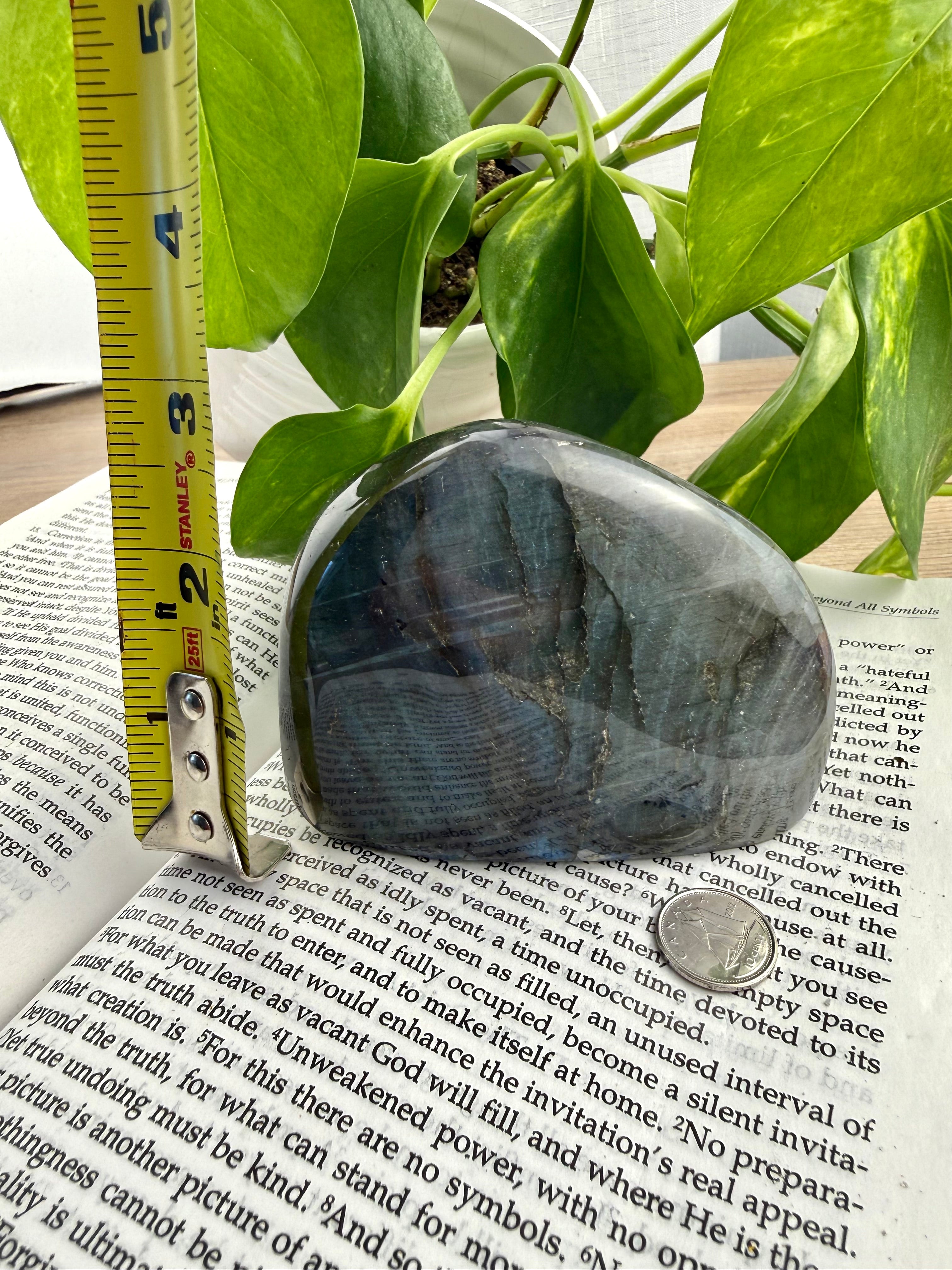 Labradorite with measuring tape showing it to be about 3 inches high 