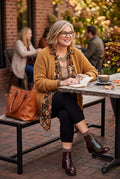 Leave Nothing But Footprints Bamboo LNBF 3/4 Leggings | Size XL on woman sitting outside at cafe reading book