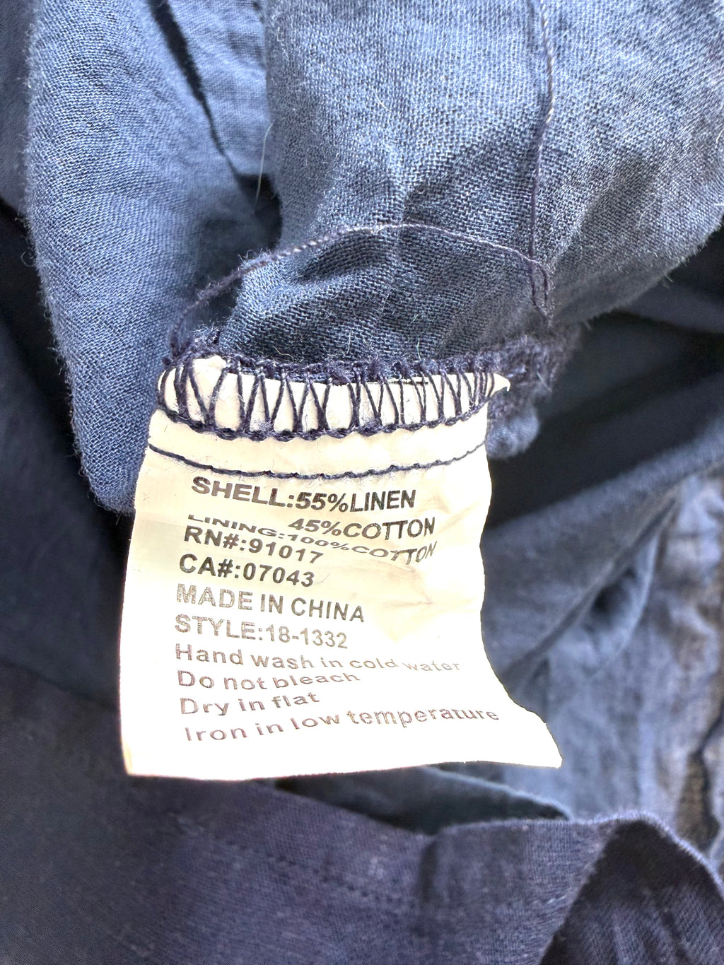 Close-up of a clothing label on a denim fabric background