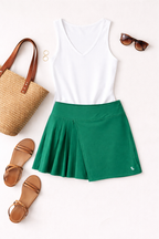 Lolë Pleated Athletic Skort | Size S at Blue Sparrow Shop flatlay with sandals, purse, sunglasses