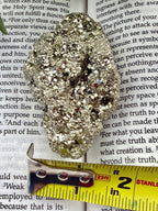 Pyrite with measuring tape showing it to be about 1.5=2" wide 