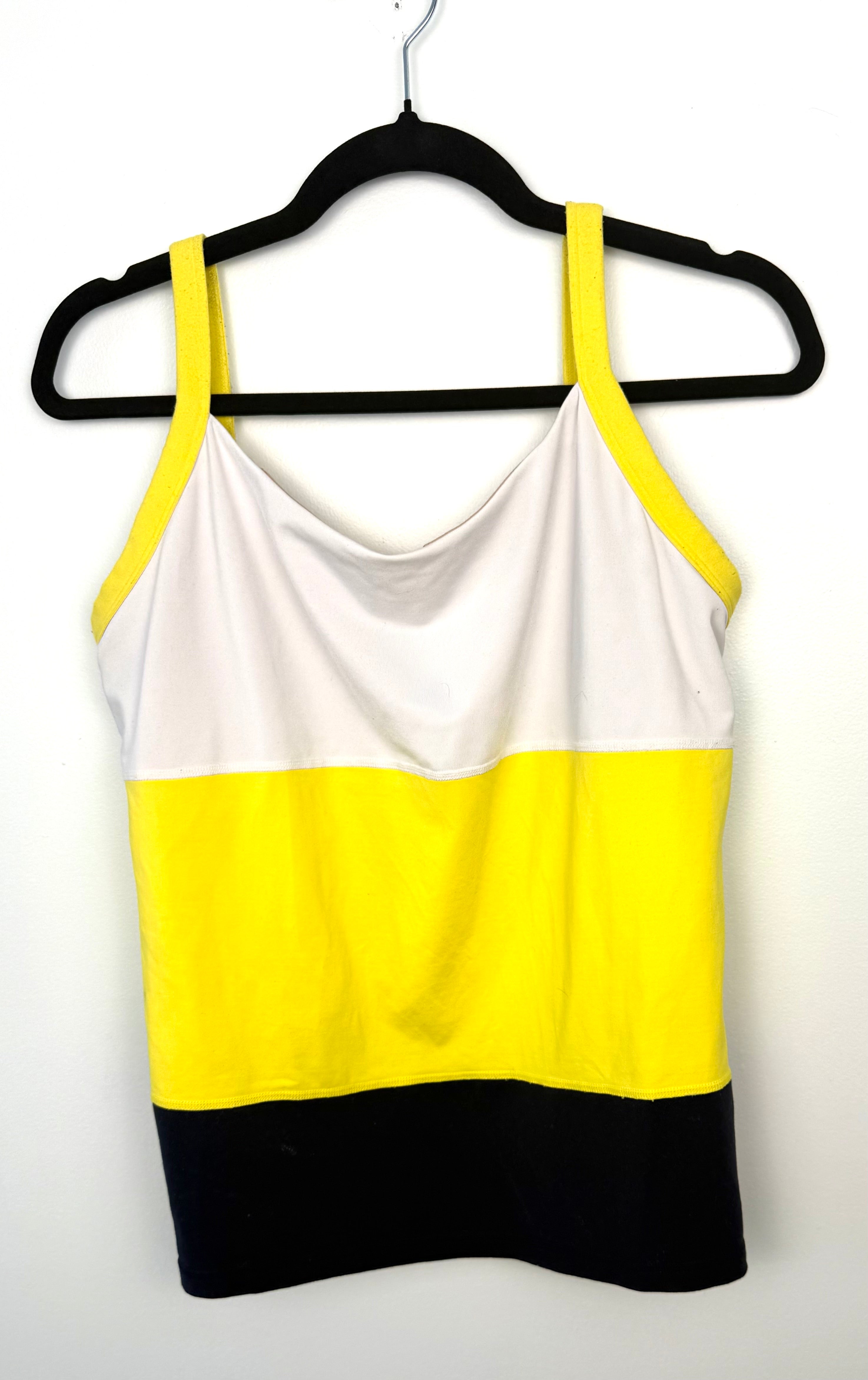 Front view of Lululemon colour block athletic tank top featuring white upper panel, bright yellow midsection, and black lower band with wide yellow straps.