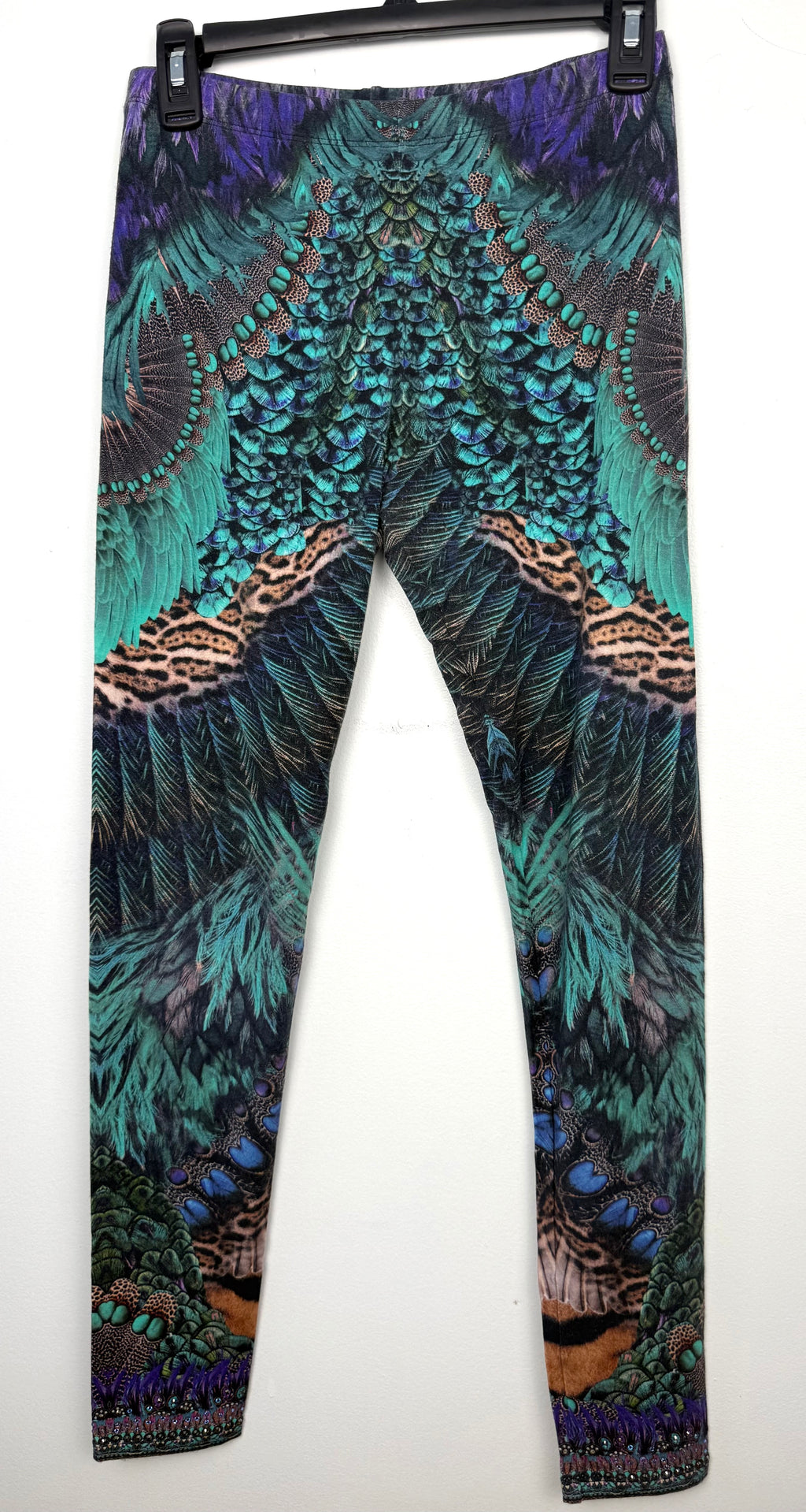 Luxury Camilla Franks resort wear leggings featuring a vibrant animal print design with crystal embellished ankle detailing on hanger