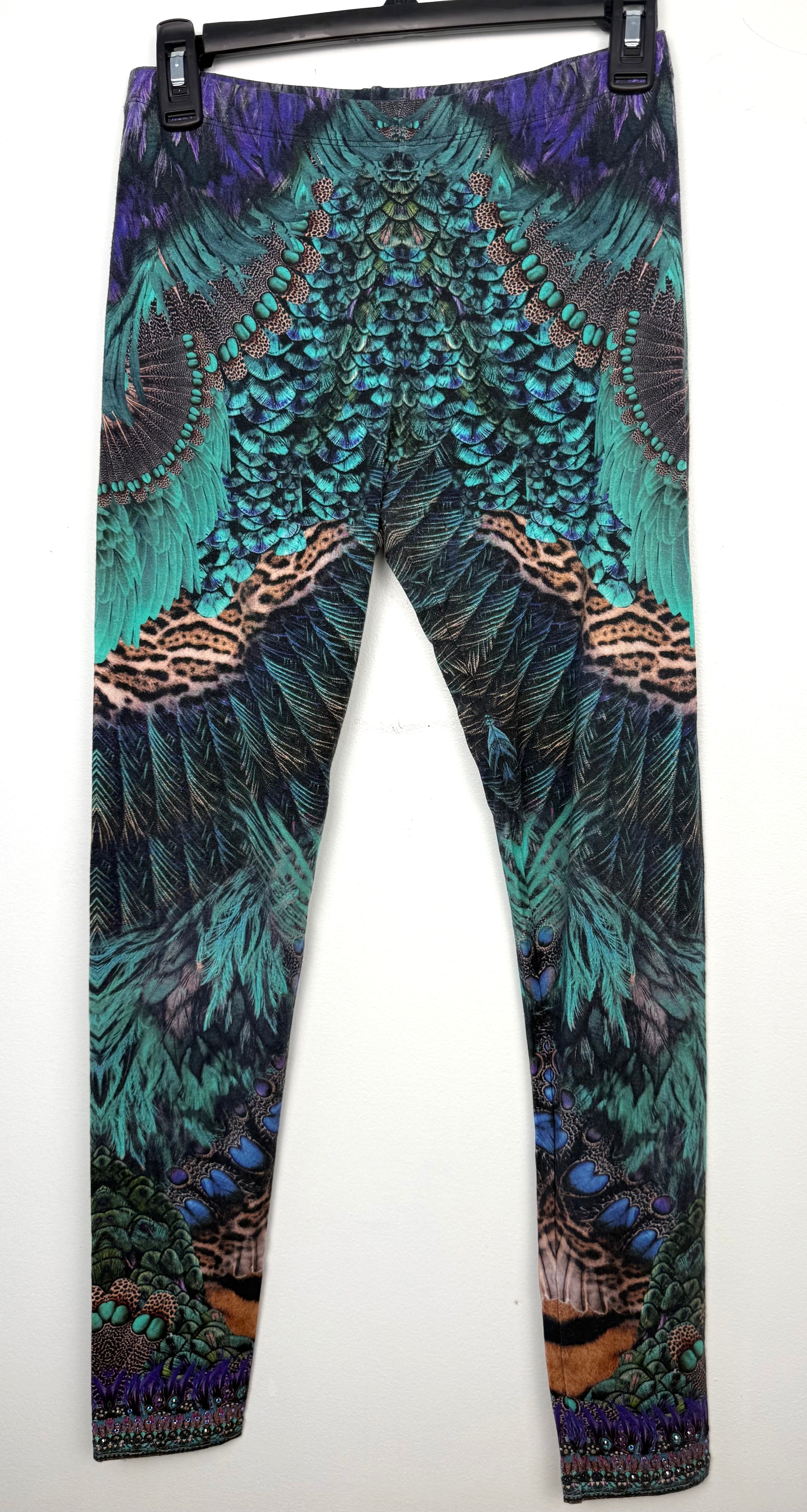 Luxury Camilla Franks resort wear leggings featuring a vibrant animal print design with crystal embellished ankle detailing on hanger