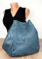 back of Made in Canada  Kunitz handcrafted leather tote bag beside mannequin to show scale 