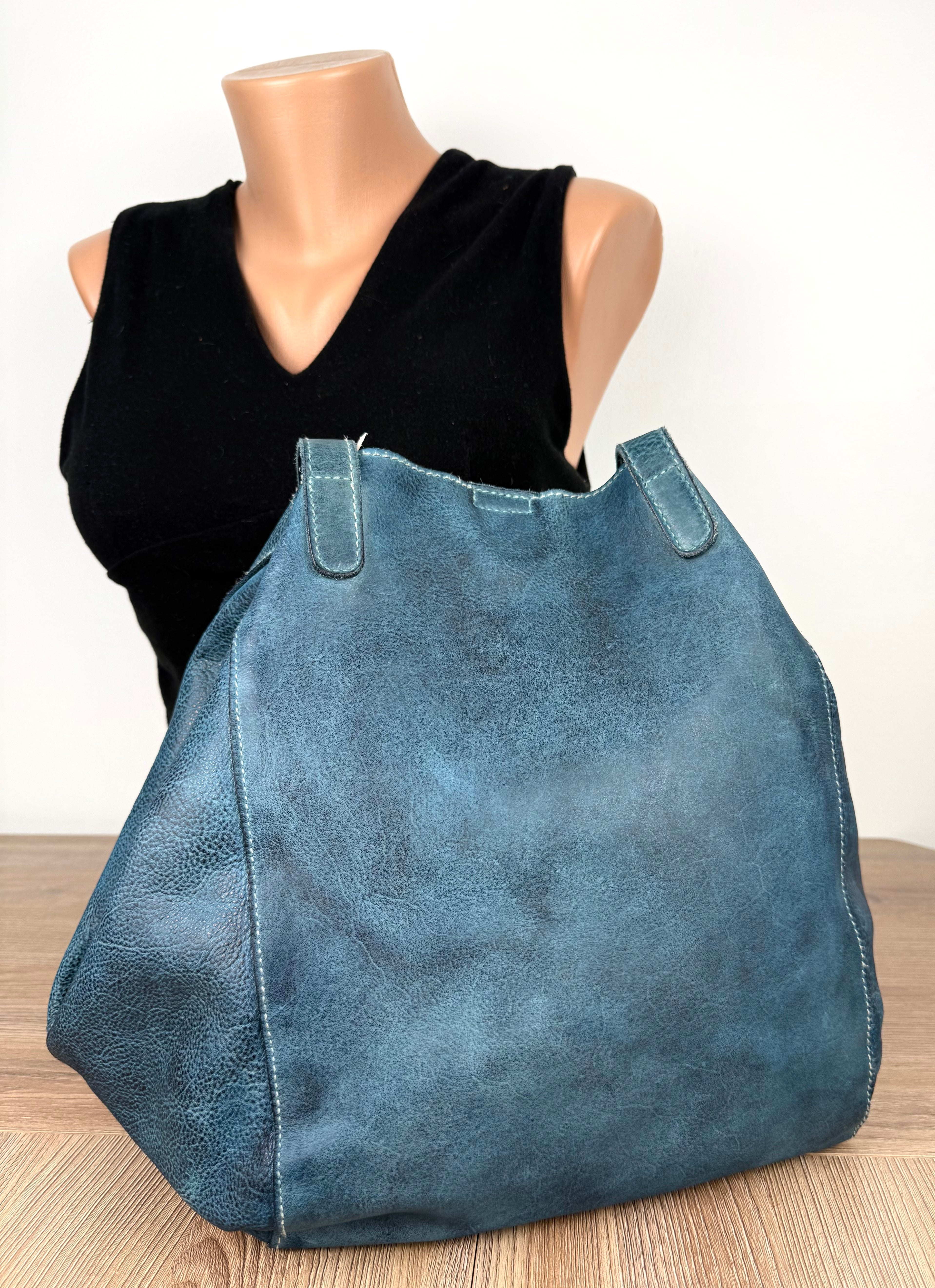 back of Made in Canada  Kunitz handcrafted leather tote bag beside mannequin to show scale 
