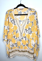 Made in Italy Boho floral kaftan top with yellow and cream print, crochet V neckline, and tassel hem, lightweight Italian viscose blouse on hanger