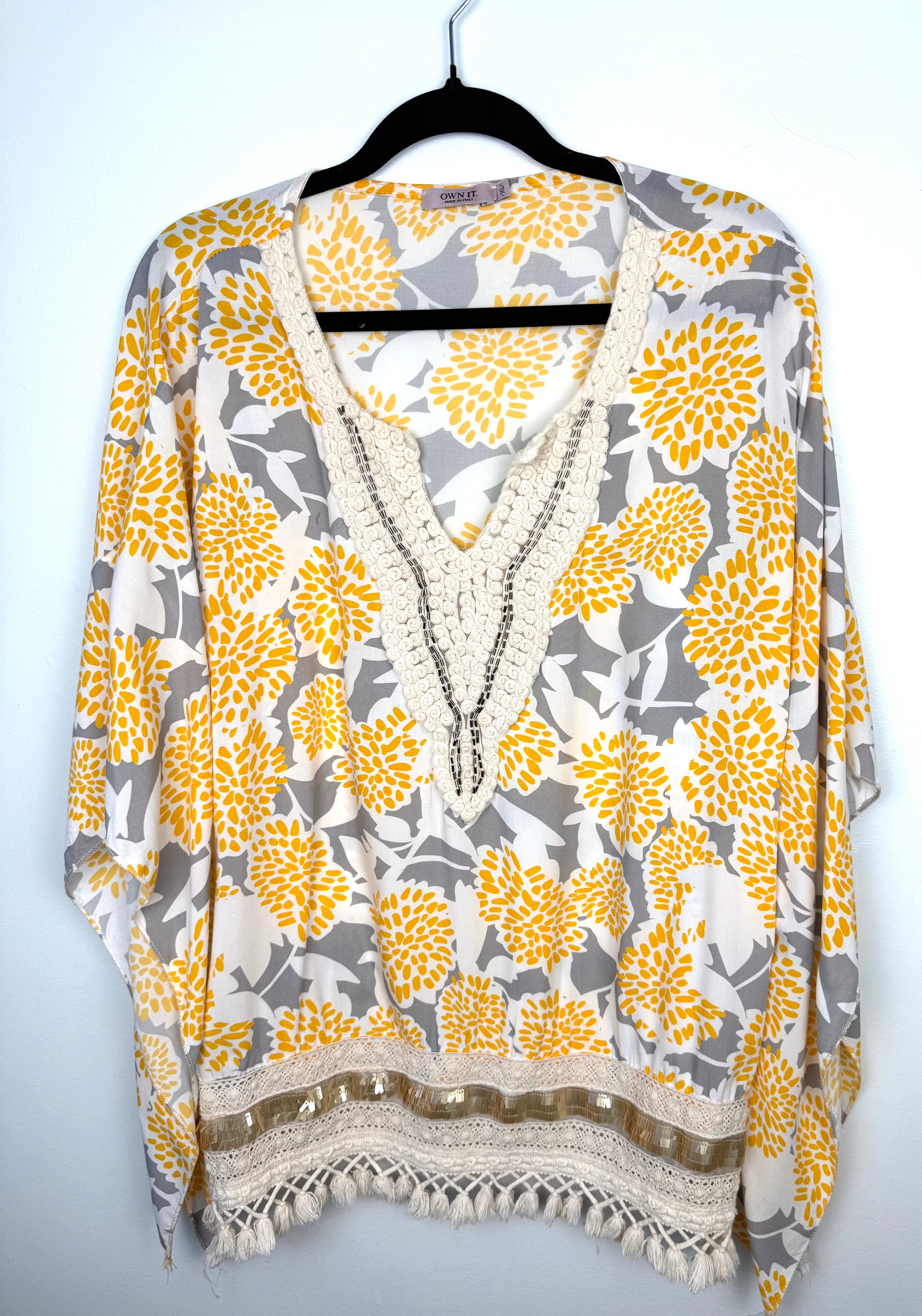 Made in Italy Boho floral kaftan top with yellow and cream print, crochet V neckline, and tassel hem, lightweight Italian viscose blouse on hanger