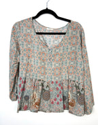 Mahla women’s boho peplum blouse in size large featuring a soft sage green and coral mixed print design with 3/4 sleeves and button front detail. Lightweight 100% modal fabric with flowy drape and relaxed fit. front view 