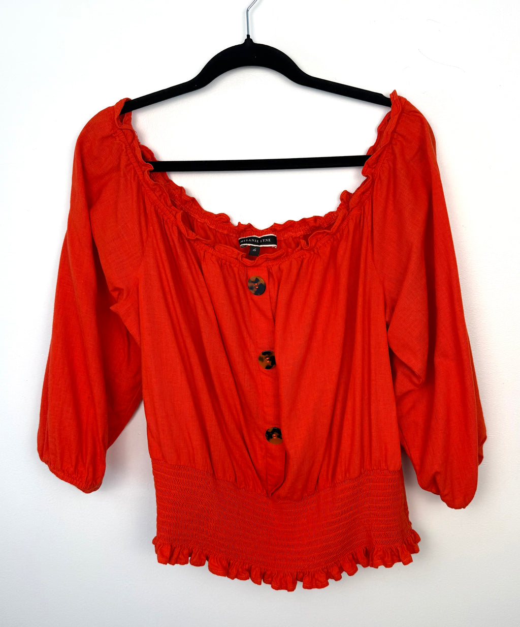 Melanie Lyne orange peasant blouse on hanger