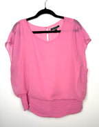 Melanie Lyne pink chiffon blouse with smocked waist and flutter sleeves on hanger