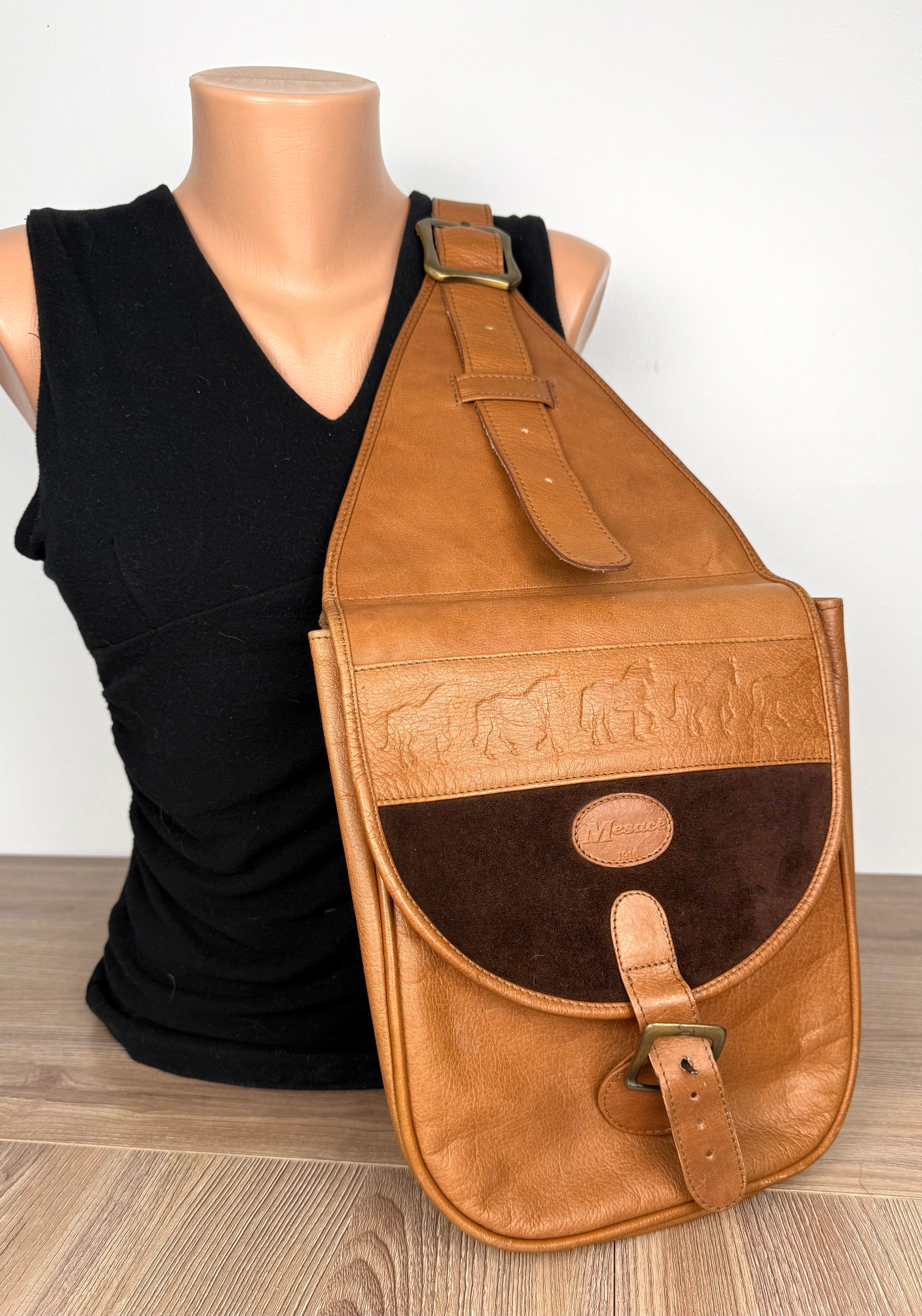 Mesace 1910 Cognac Leather Western Saddle Sling Bag on mannequin to show size