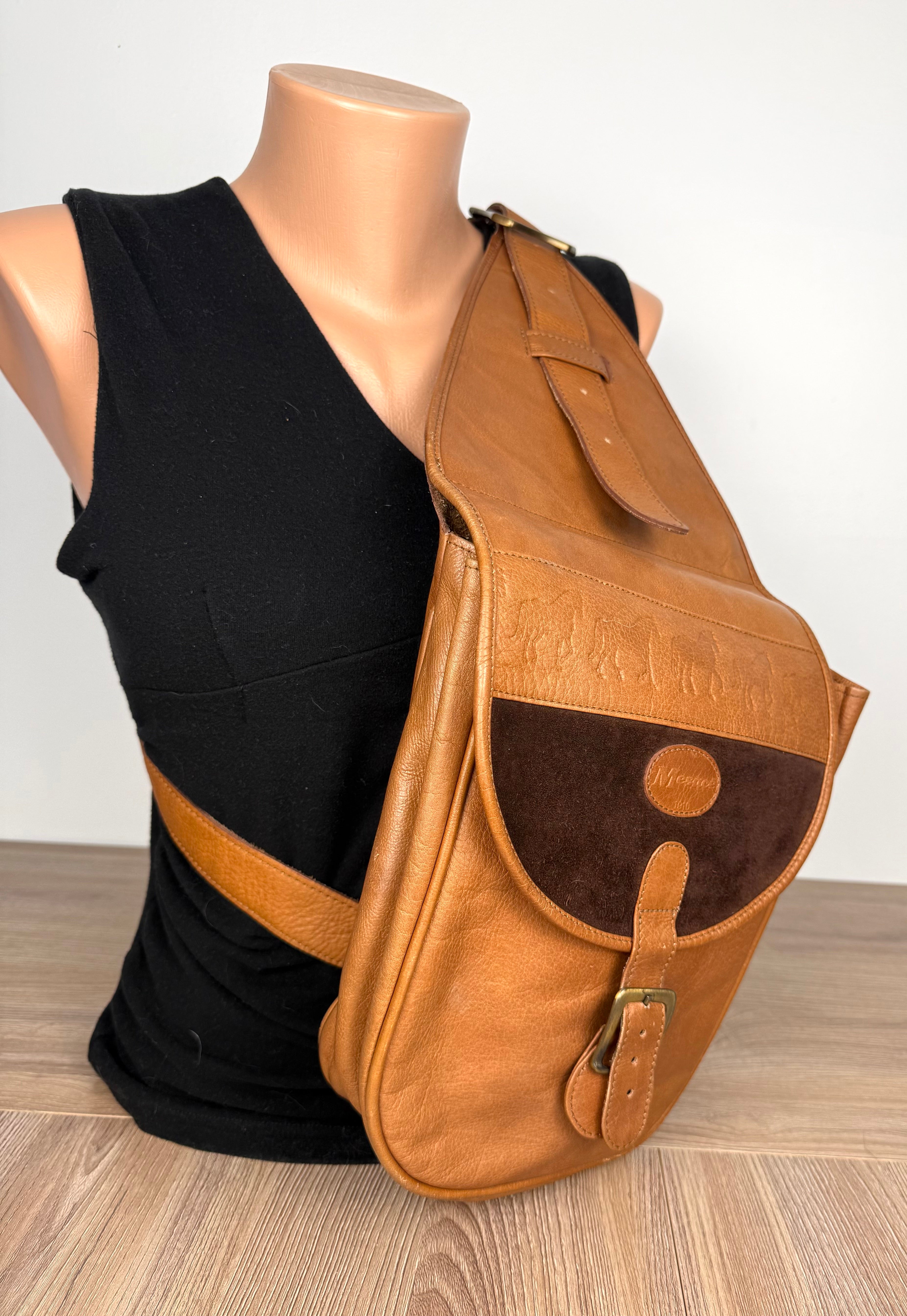Mesace 1910 Cognac Leather Western Saddle Sling Bag slung over mannequin 