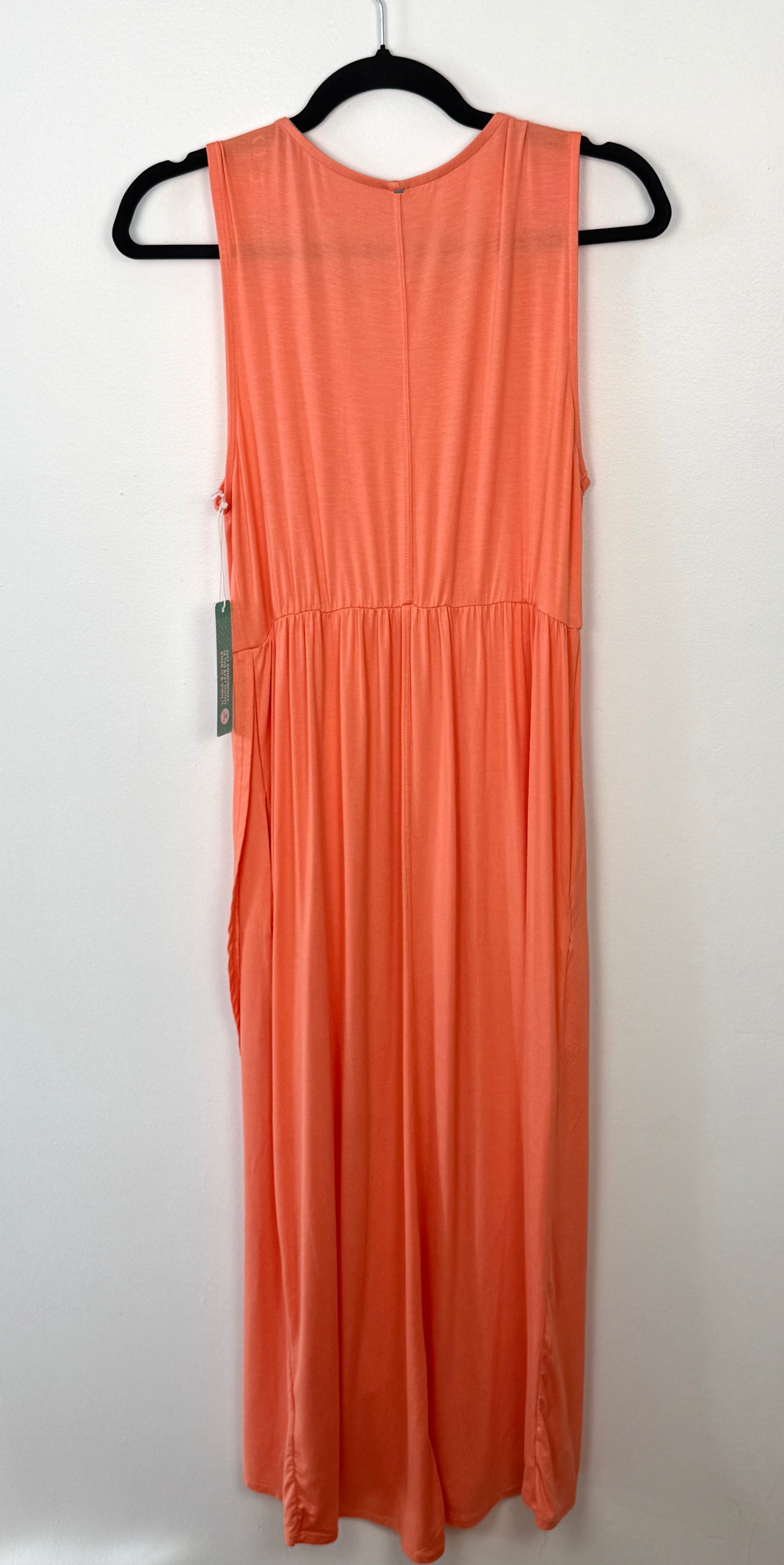 back view of sweet legs coral coloured sleeveless dress on a hanger against a white background