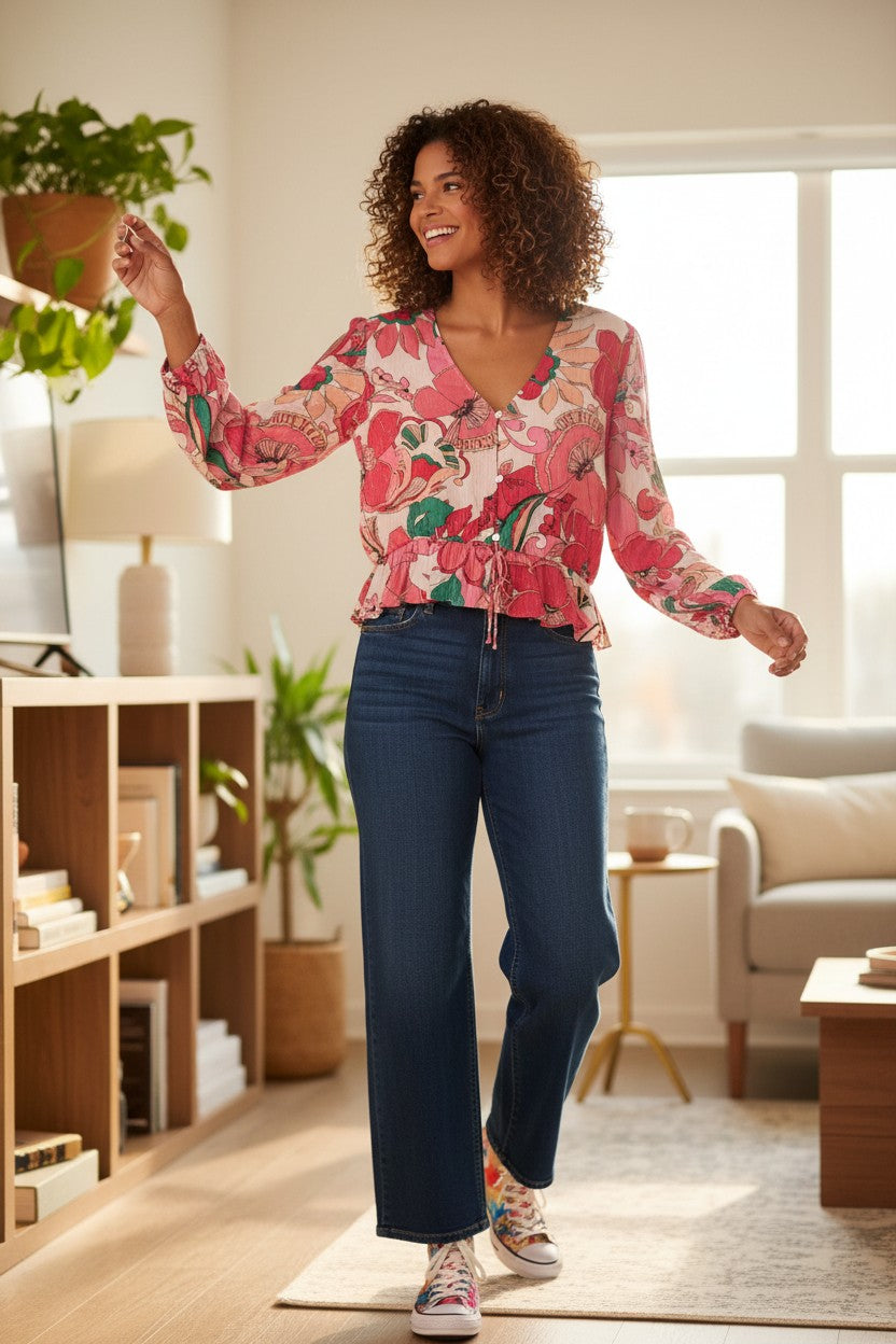 NWT Joe Fresh x Oscar Gariepy Floral Peplum Blouse at Blue Sparrow Shop  on woman dancing in living room 