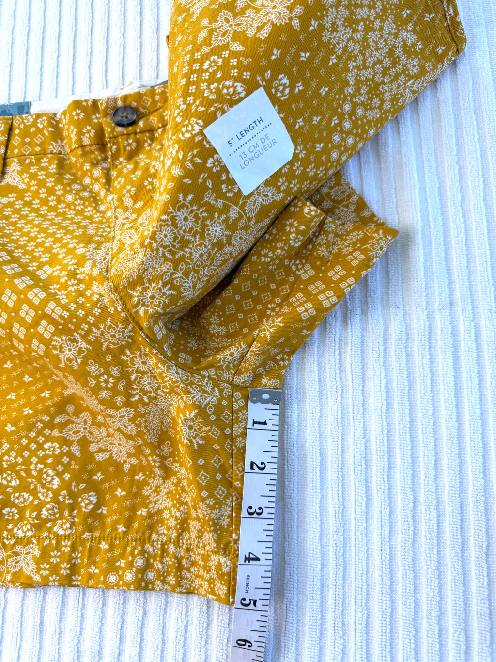 NWT Old Navy 100% Cotton Mustard Floral Print Chino Shorts — 5" | Size 12 at Blue Sparrow Shop measuring 5" inseam