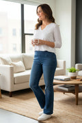 NYDJ Foundry Pull-On Bootcut Jeans – Medium Wash Stretch Denim Jeans on woman standing in her living room
