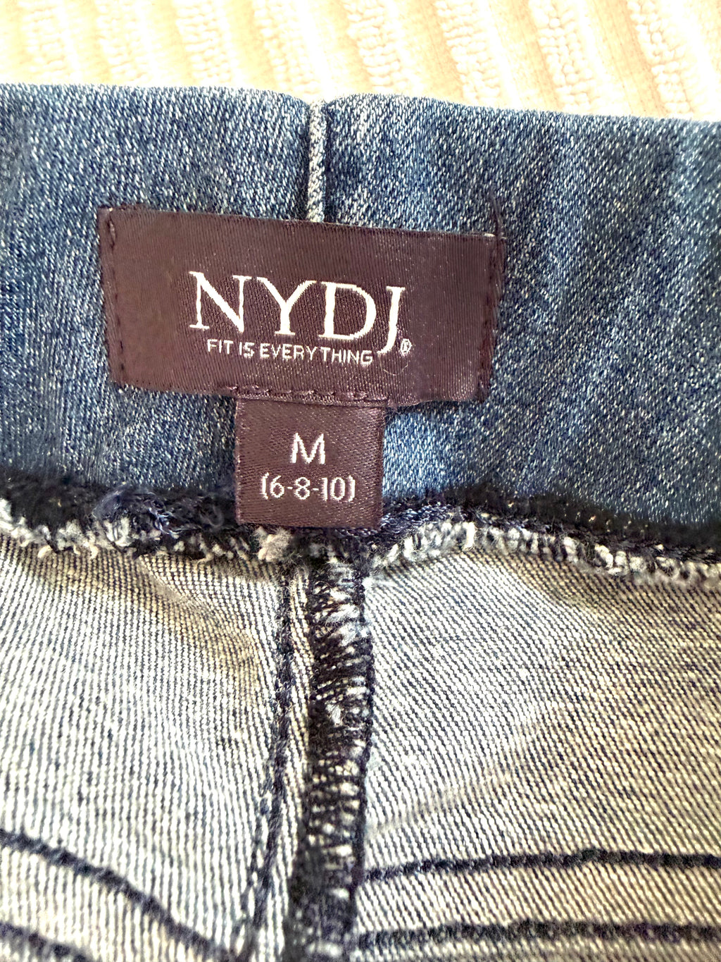 NYDJ logo tag with size tag showing M on NYDJ Foundry Pull-On Bootcut Jeans – Medium Wash Stretch Denim Jeans