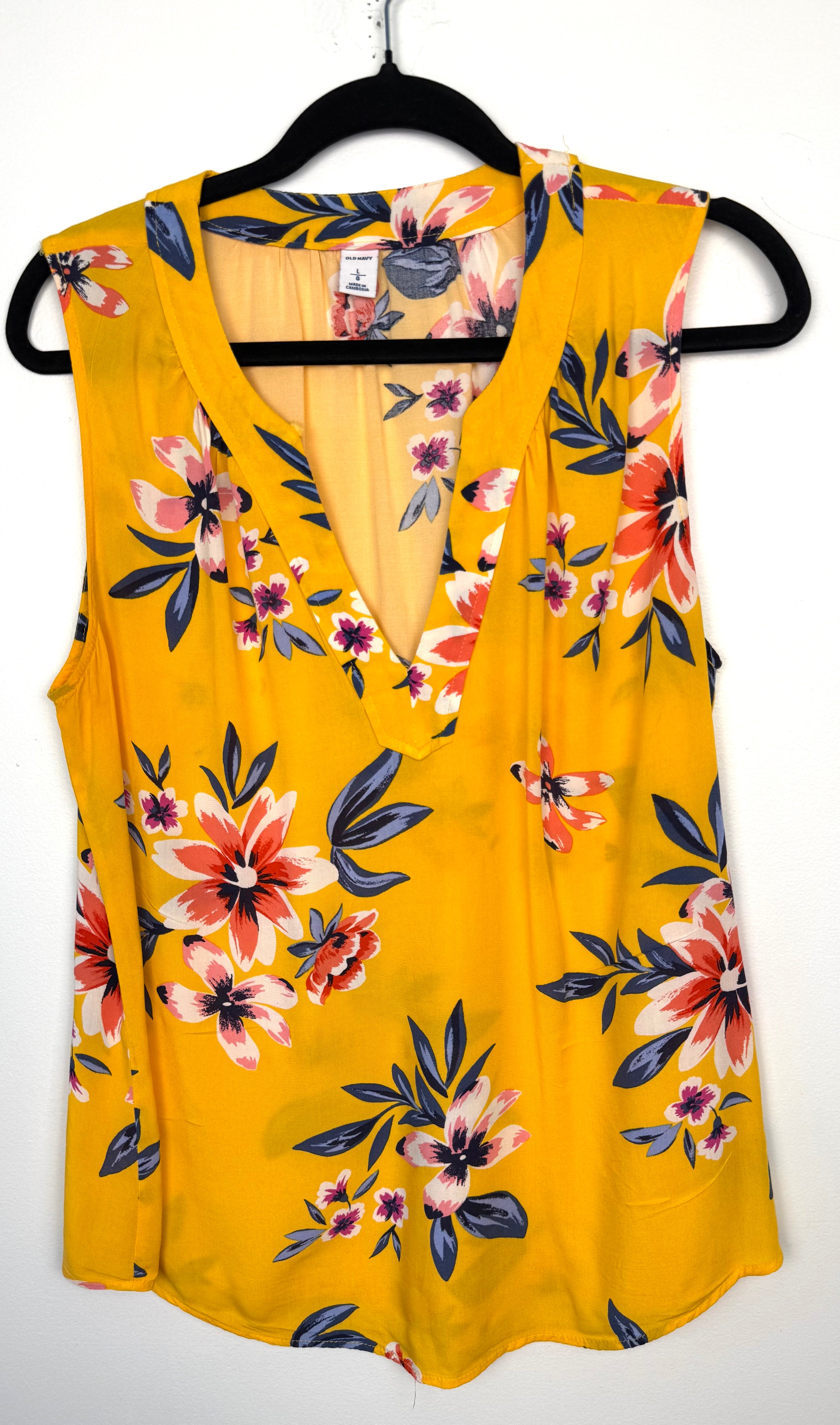 front of Old Navy Floral Sleeveless V-Neck Blouse — Golden Yellow | Coral and Navy Print | Size L at Blue Sparrow Shop on hanger