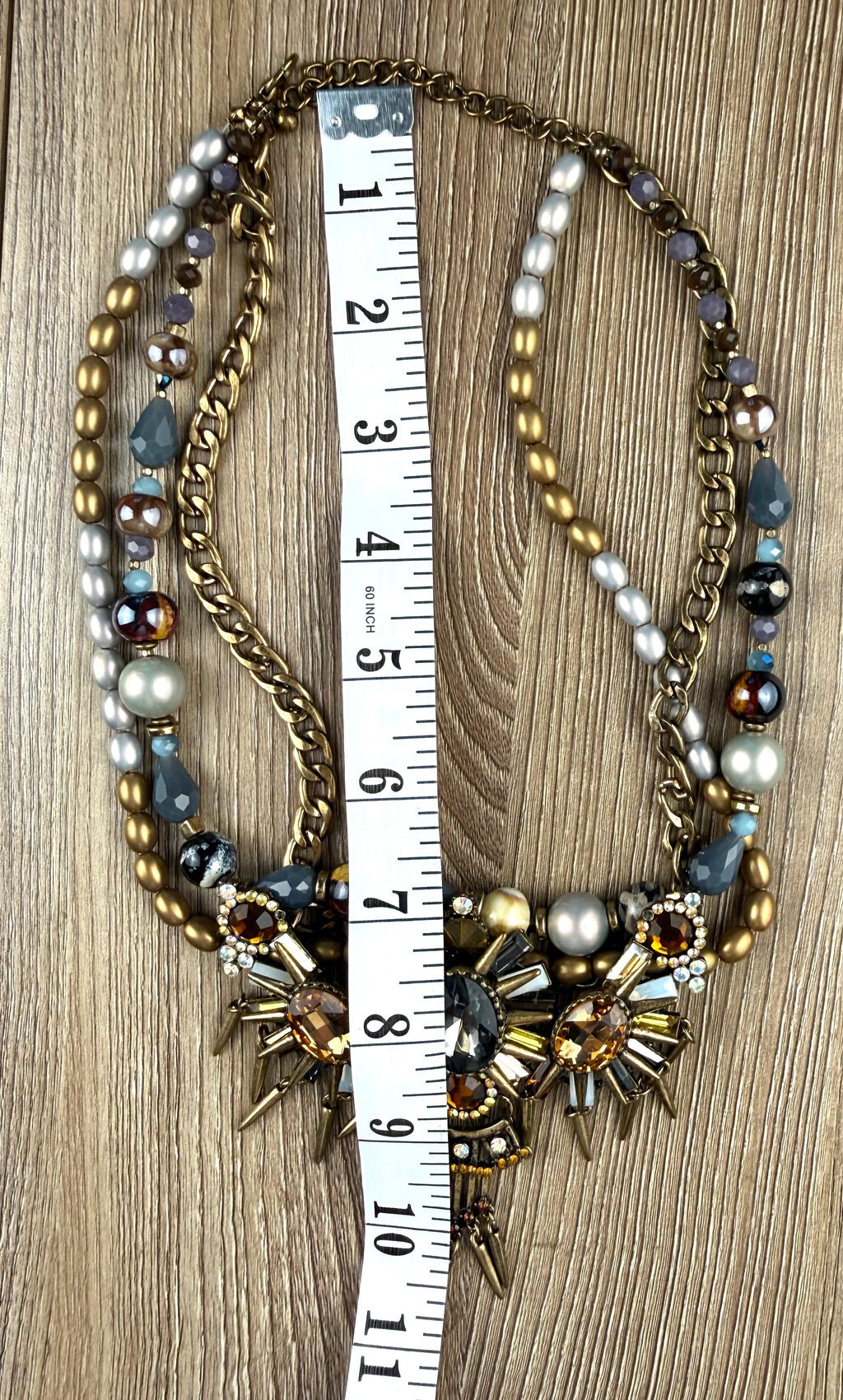 Ornate statement necklace with crystal crown centrepiece and spike accents measuring 14" neck 
