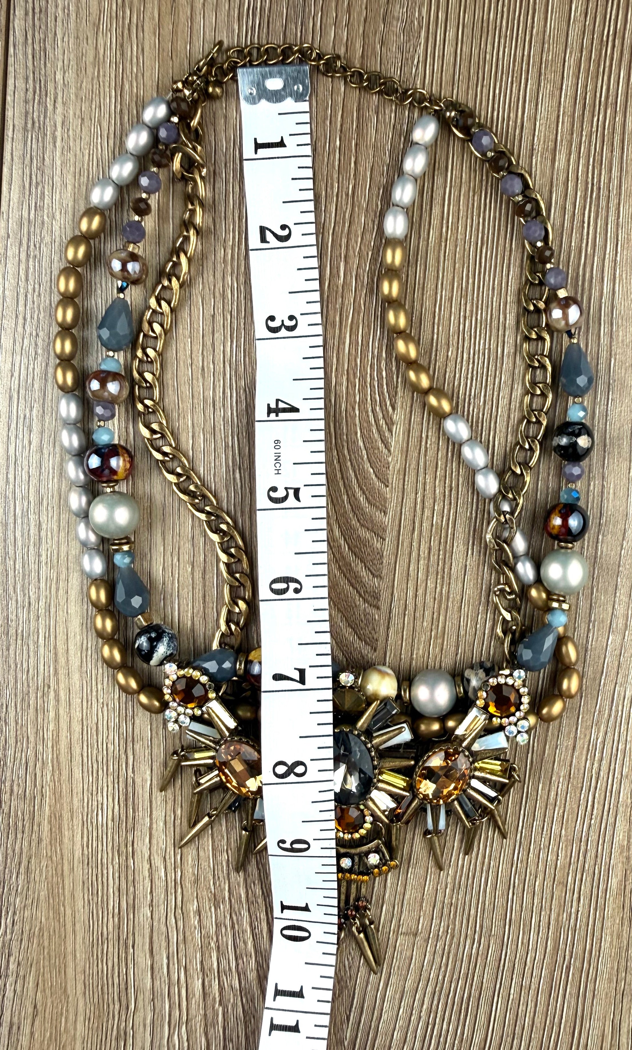 Ornate statement necklace with crystal crown centrepiece and spike accents measuring 14" neck 