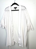 Oversized open front boho layering piece with floral eyelet embroidery and ruffle sleeves.
