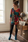 Papillion Tunic Sweater Dress | Size M on ai woman reaching for something in a drawer 