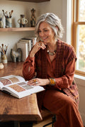 Paprika coloured Handmade Cardigan | Size S on woman sitting at desk reading book