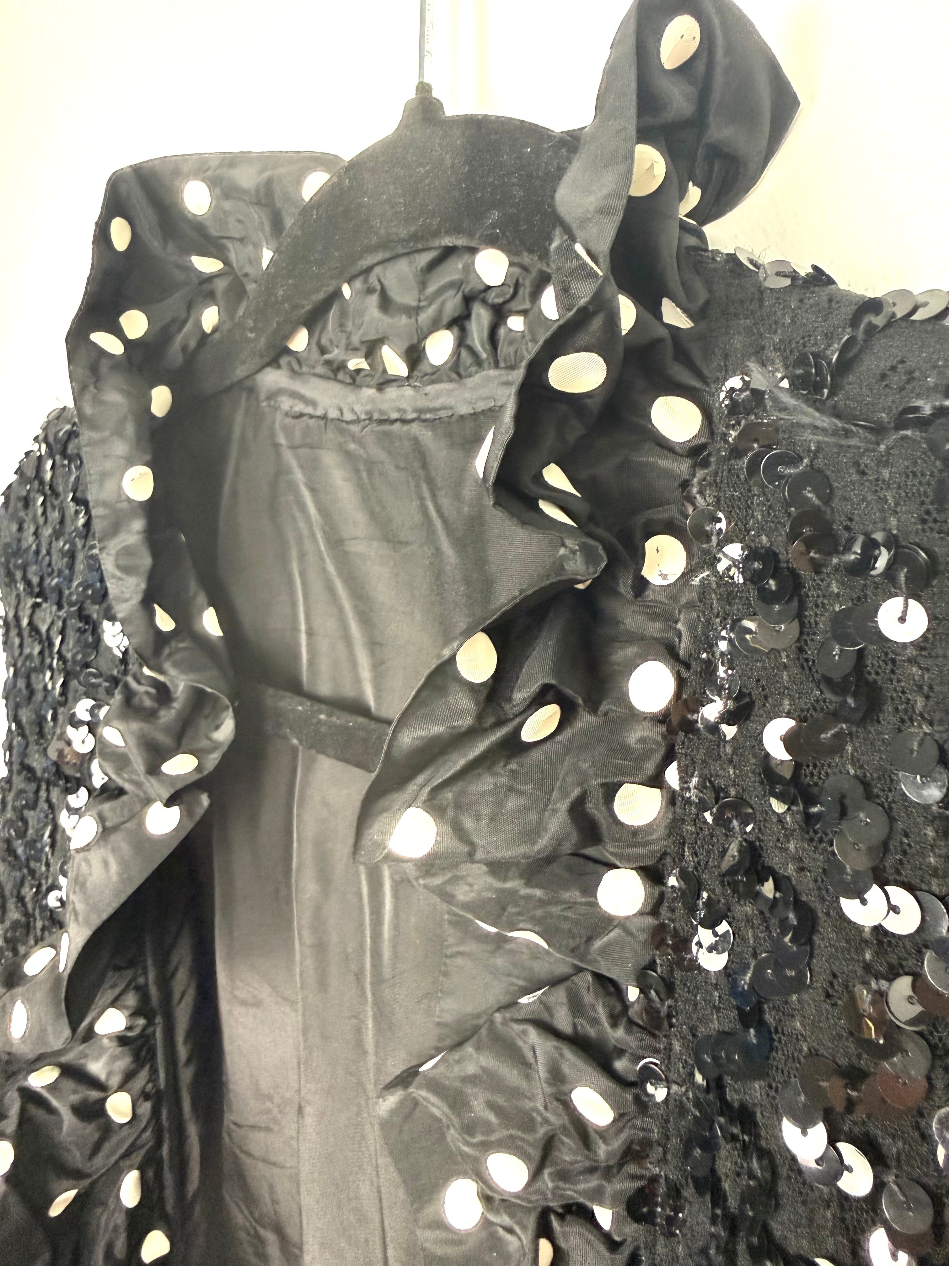 Polka dot satin ruffle and black sequin detail close up on black sequin jacket