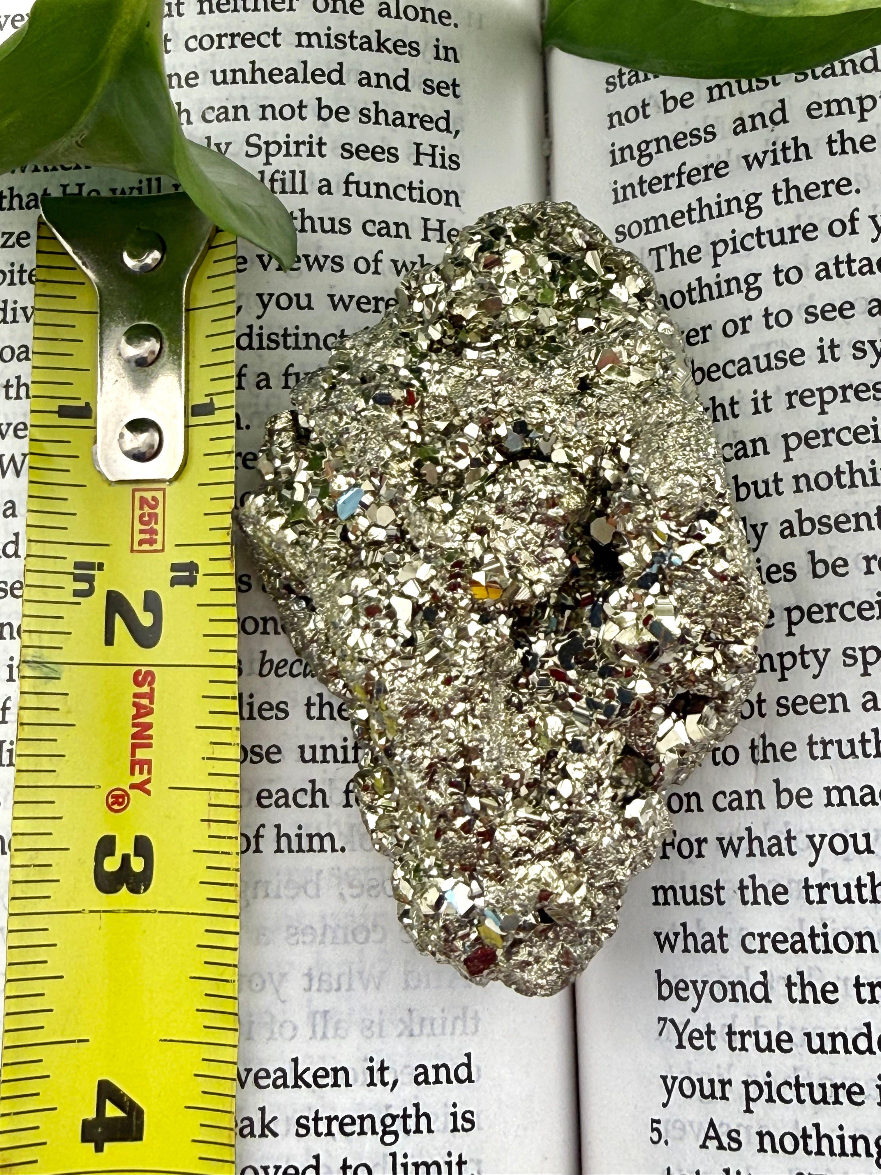 Pyrite with measuring tape showing it to be approx 4 inches long 