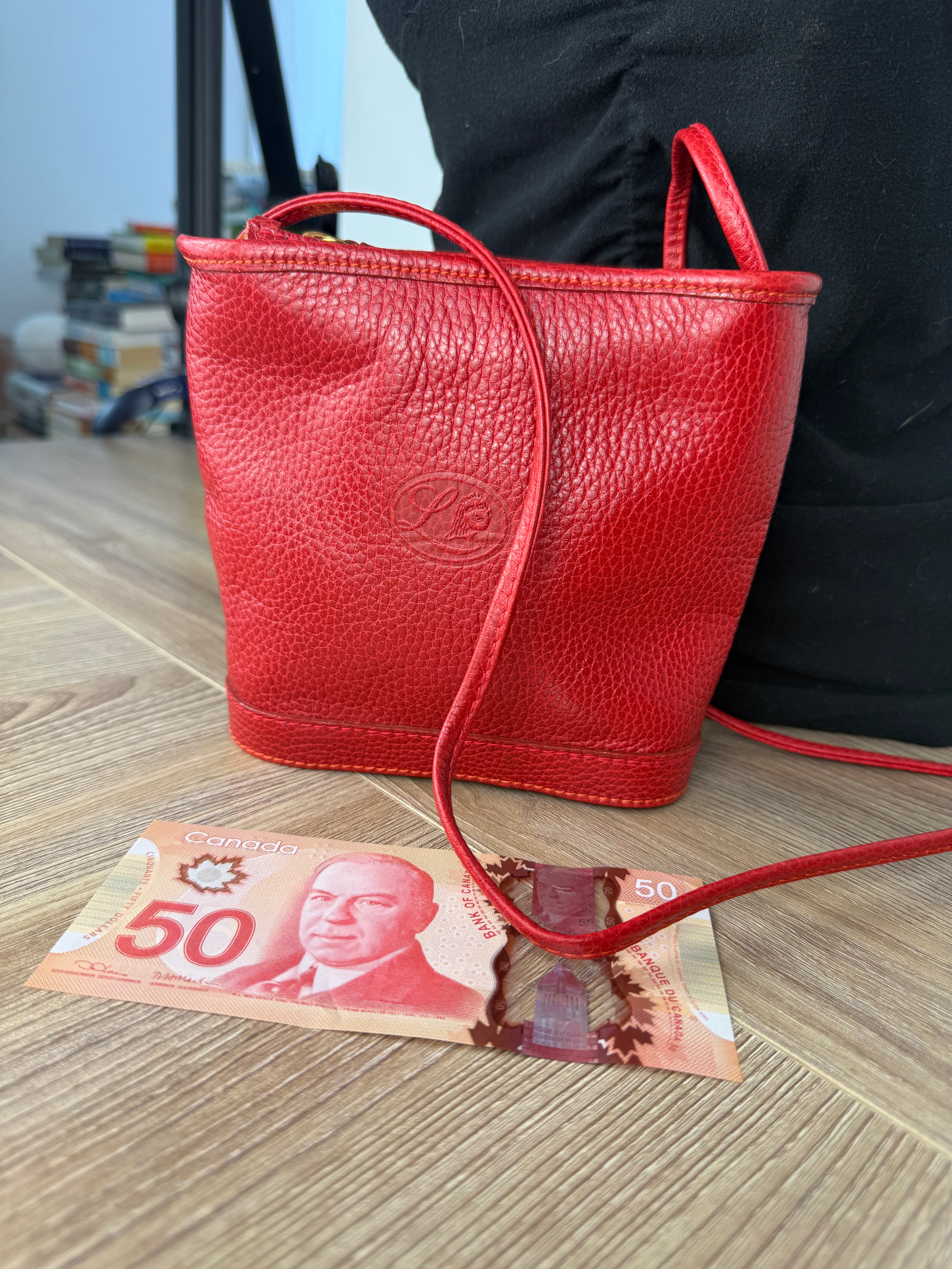 Small red leather crossbody purse size comparison with Canadian currency