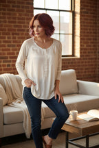 Resale Go Silk Washable Silk Long Sleeve Blouse at Blue Sparrow Shop on woman standing beside a couch wearing jeans