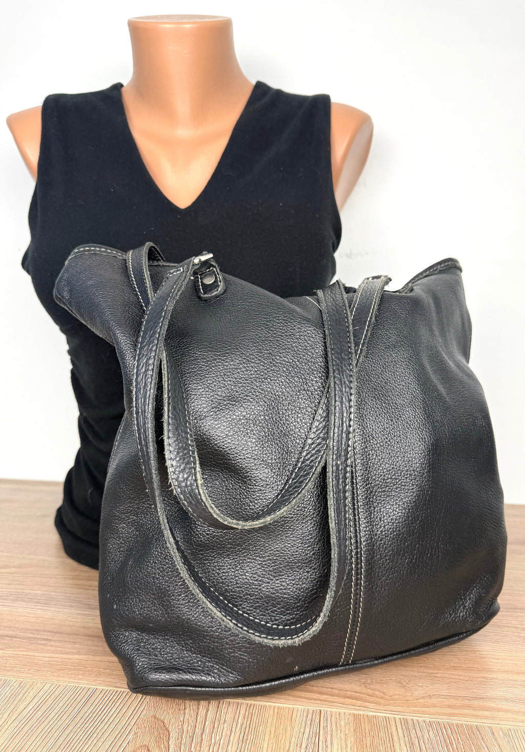 back of Roots Canada Black Pebbled Leather Tote bag on mannequin to show size