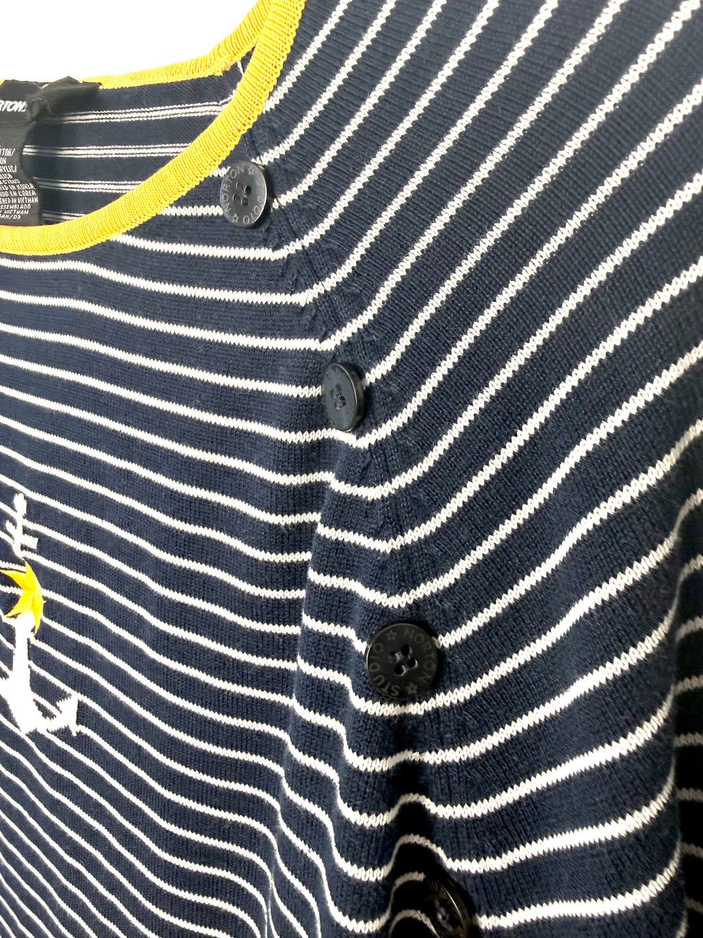Shoulder button detail on navy and white striped nautical sweater.