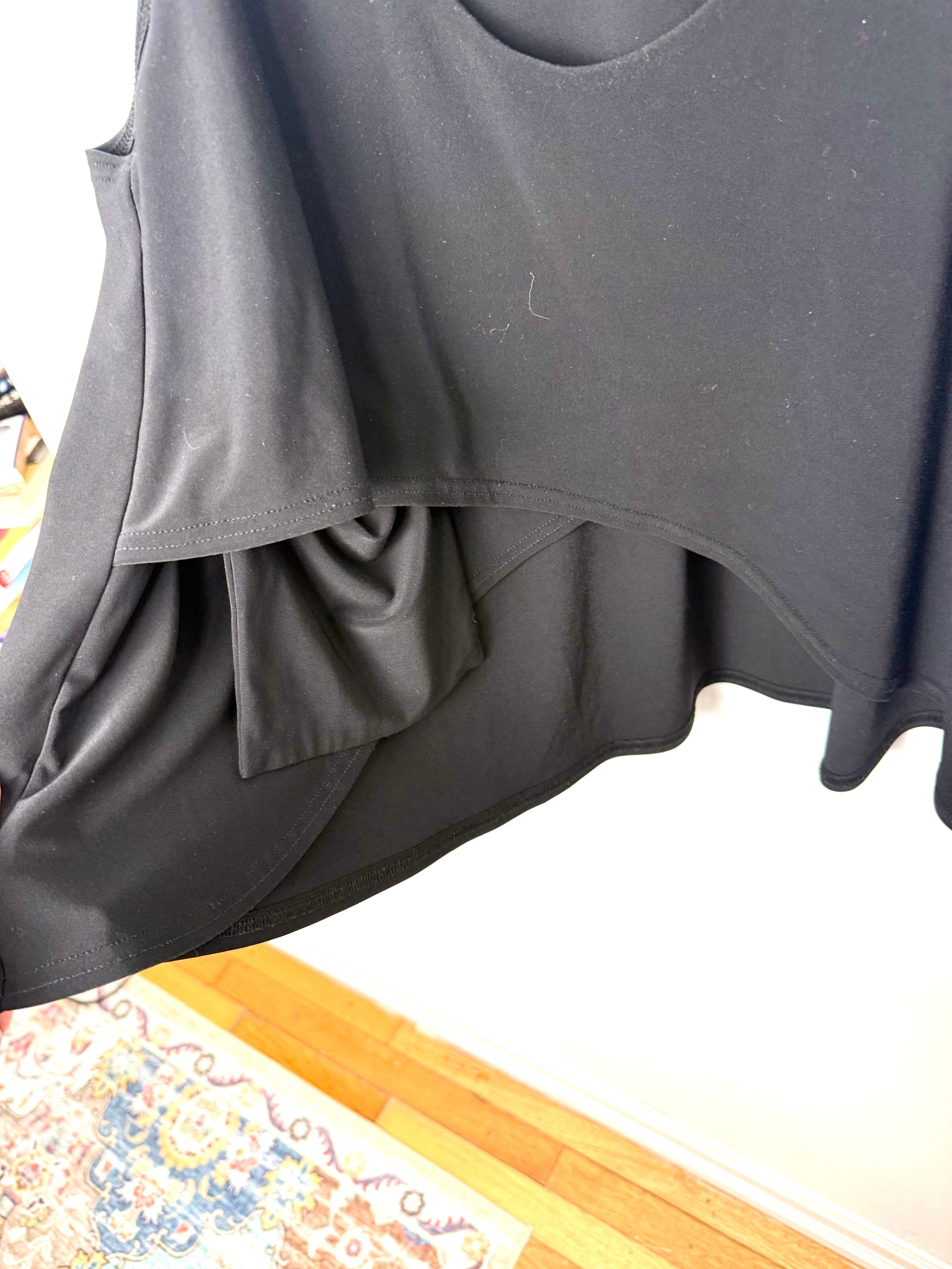 Showing the inside pocket on the black sympli tunic top 