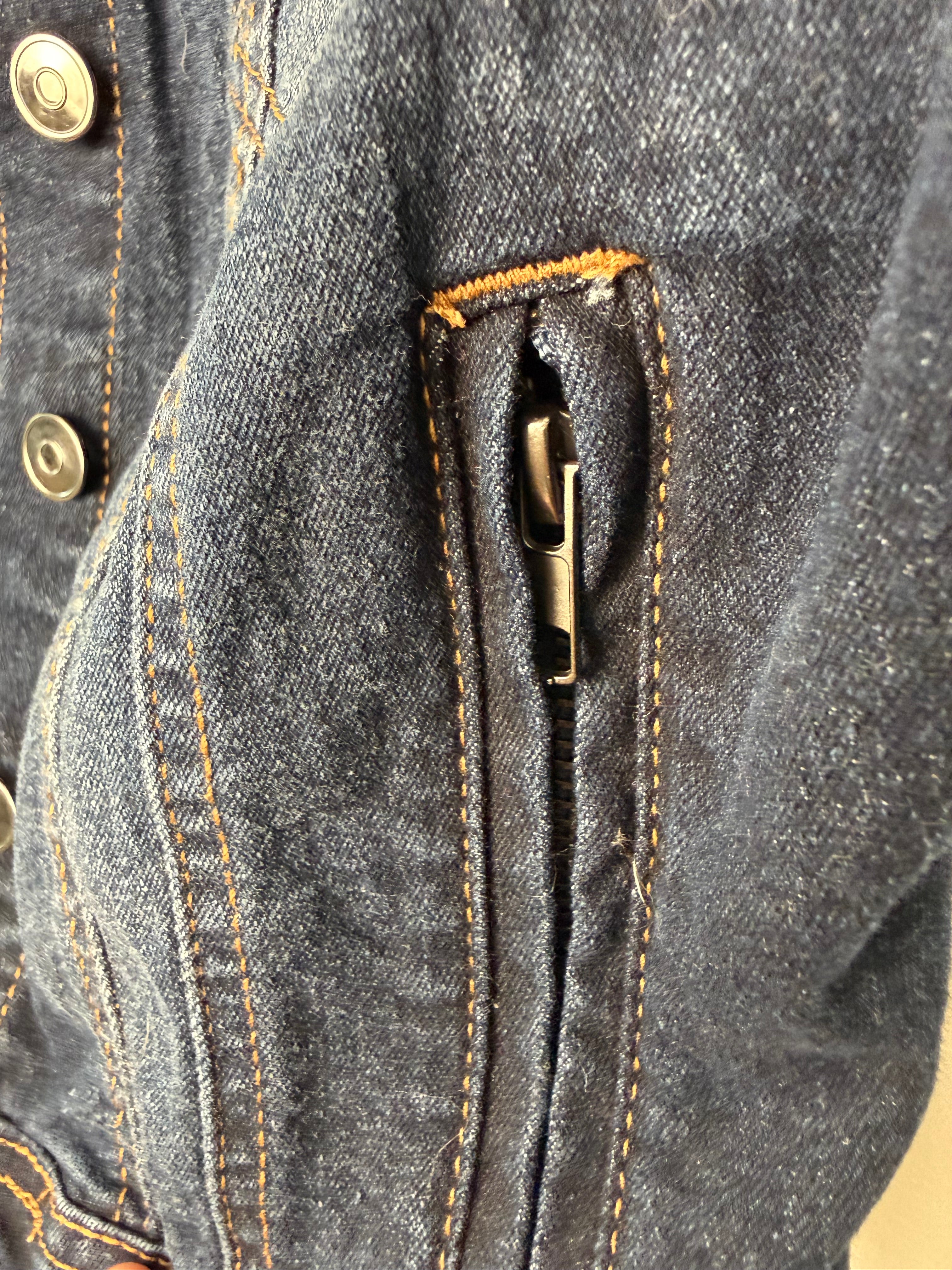 Side zipper detail on distressed denim vest for women