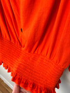 smocked bottom on Melanie Lyne orange peasant blouse