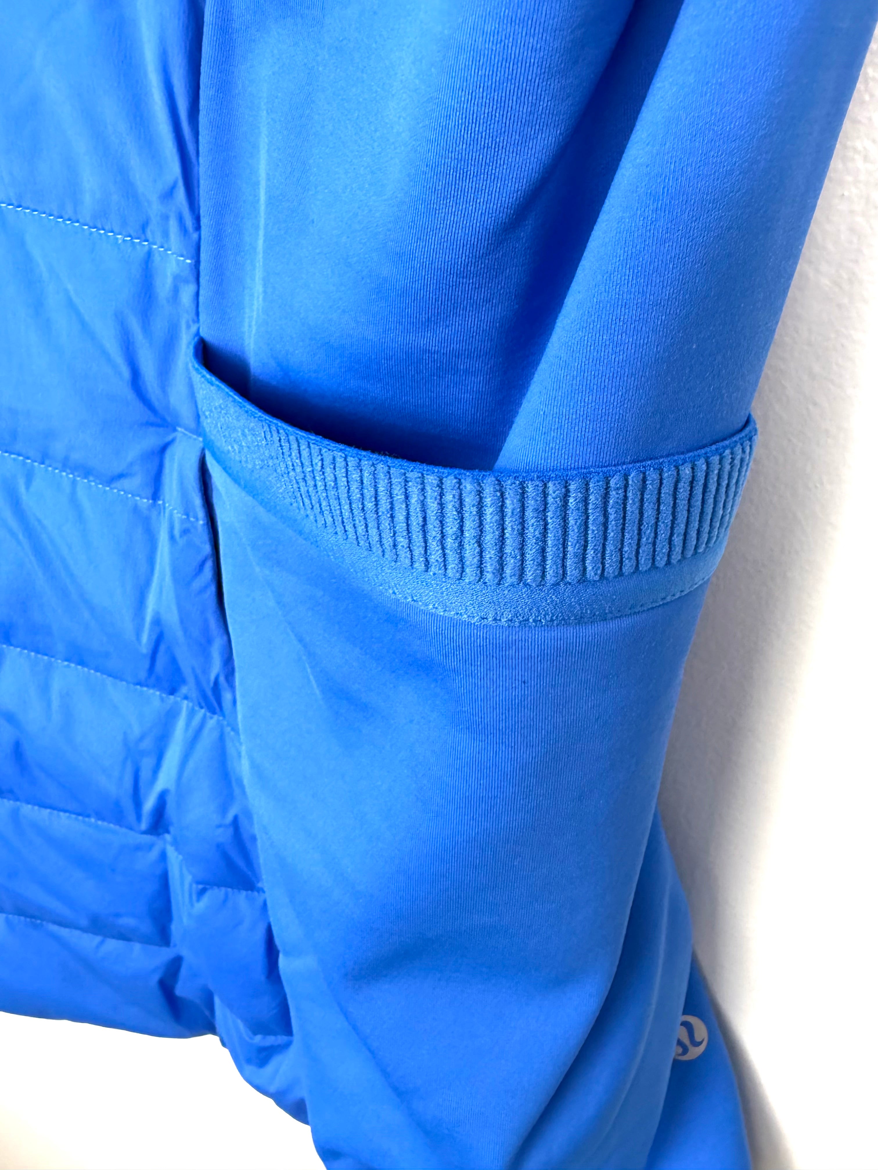 Stretch side panel detail on Lululemon hybrid vest fitted athletic silhouette.