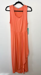 Coral coloured sleeveless dress on a hanger against a white background made by sweet legs canada