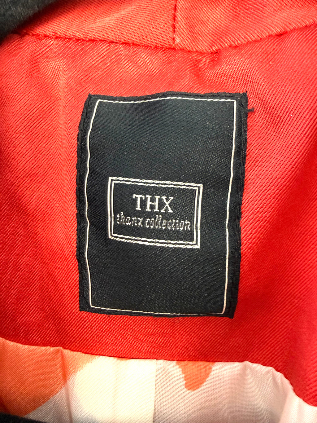 THX label inside THX Merci Collection ruffle trench coat jacket