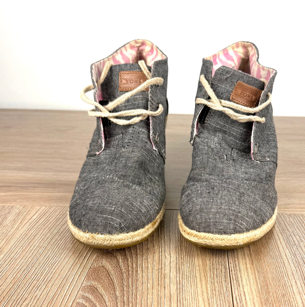 TOMS Chambray Espadrille Wedge Booties on table 
