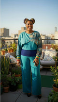 Teal Peacock Print 2-Piece Knit Set — Wide-Leg Pants + Draped Top, Size XL at Blue Sparrow Shop on woman outside on patio 